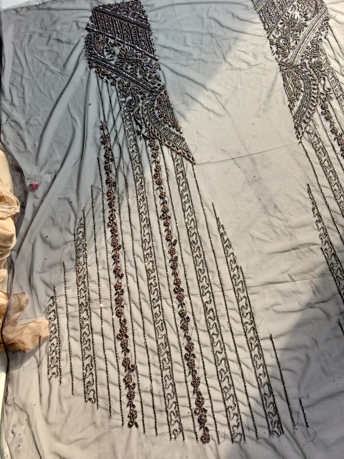 Hand embroidery beadwork detail on a kaftan panel