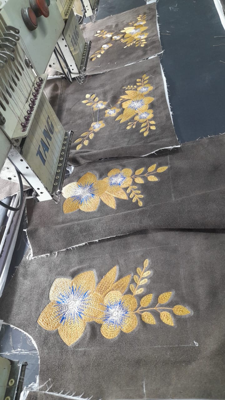 Machine embroidery floral motifs stitched on fabric panels